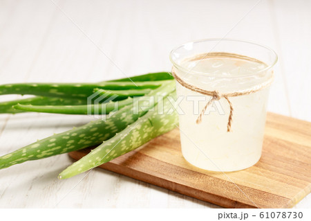aloe vera juice in a glass on wooden paddle board 61078730