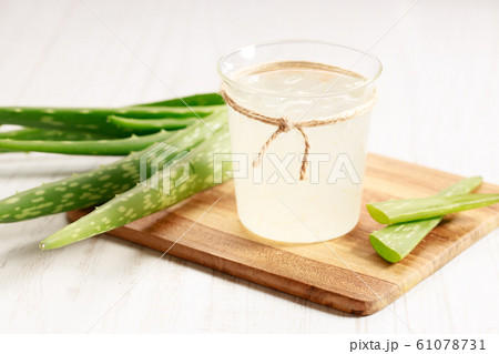 aloe vera juice in a glass on wooden paddle board 61078731