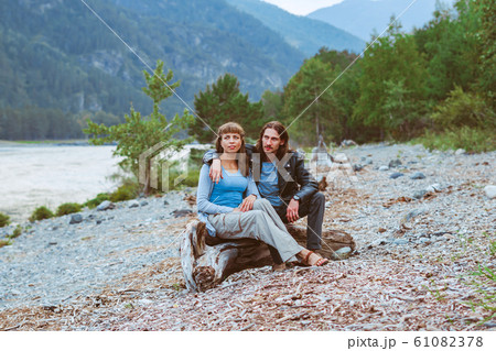 a couple of lovers sitting near the river a couple of lovers sitting near the river 61082378
