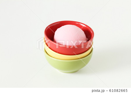 pink ice cream in red ceramic cup pink ice cream in red ceramic cup 61082665