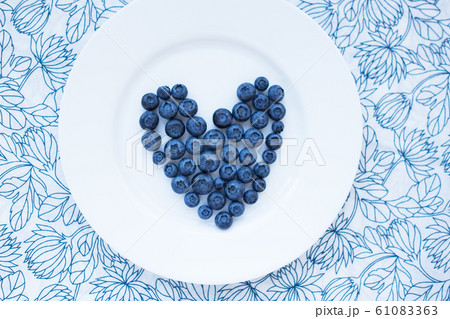 blueberries in a heart shape on a white plate 61083363