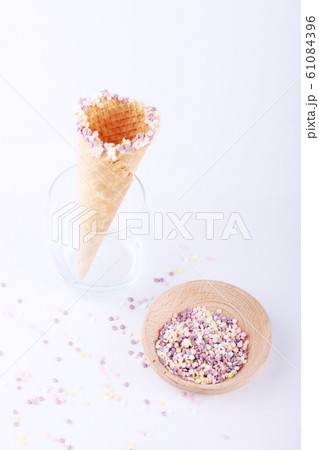 empty ice cream cones with colorful sprinkles 61084396