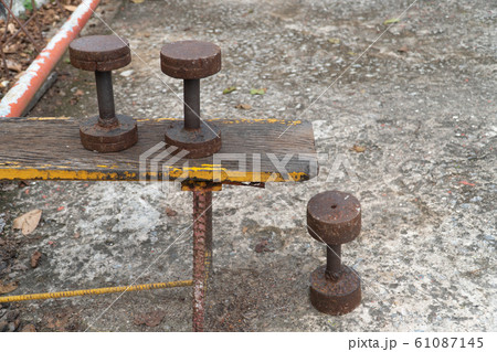 Diy metal iron dumbbell on a outdoor fitness gym floor Diy metal iron dumbbell on a outdoor fitness gym floor 61087145