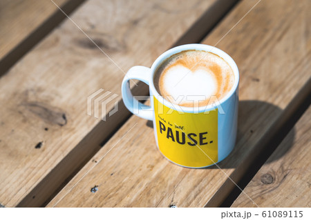 A tasty cup of coffee on a wooden table A tasty cup of coffee on a wooden table 61089115
