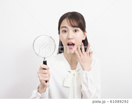 ルーペを持って驚く女性 ルーペを持って驚く女性 61089292