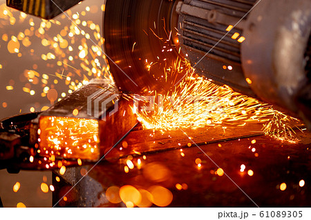 Cutting industrial metal with grinder. Sparks while grinding iron 61089305