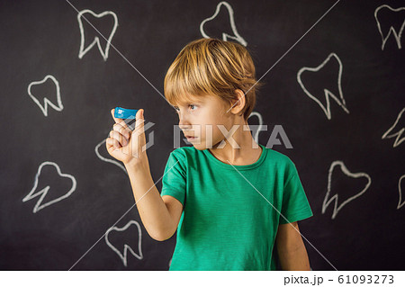 Six-year old boy shows myofunctional trainer. Helps equalize the growing teeth and correct bite Six-year old boy shows myofunctional trainer. Helps equalize the growing teeth and correct bite 61093273