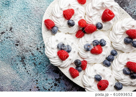 Meringues cakes with berries Meringues cakes with berries 61093652