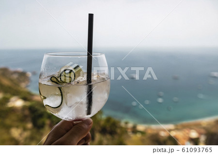 Cucumber cocktail drink in front of tropical sea Cucumber cocktail drink in front of tropical sea 61093765