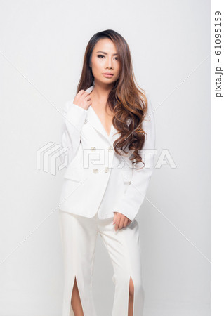 Fashion portrait woman wearing a white suit. 61095159