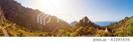 Super wide-angle scenic panoramic landscape of nature in Mallorca island. Hairpin turn between rocky mountains. Winding road to Sa Calobra picturesque port village, Escorca, Majorca, Balearic Islands. Super wide-angle scenic panoramic landscape of nature in Mallorca island. Hairpin turn between rocky mountains. Winding road to Sa Calobra picturesque port village, Escorca, Majorca, Balearic Islands. 61095656