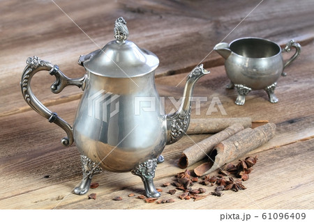 Antique silver teapot, cinnamon and star anise Antique silver teapot, cinnamon and star anise 61096409