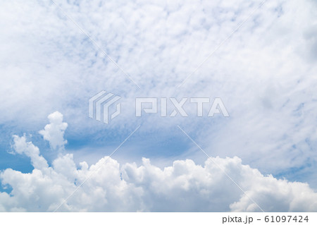 Beautiful blue clear sky with white clouds background in sunny day and copy space. Nature bright sky background image. Summer blue sky. Texture for Design. Natural cloudy Wallpaper. 61097424