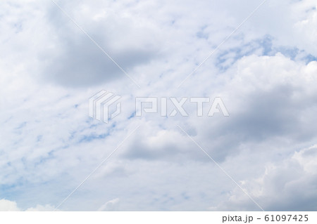 Beautiful blue clear sky with white clouds background in sunny day and copy space. Nature bright sky background image. Summer blue sky. Texture for Design. Natural cloudy Wallpaper. 61097425