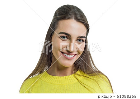 Portrait of young smiling woman in yellow sweater close-up, female with perfect white smile posing on white background, isolated Portrait of young smiling woman in yellow sweater close-up, female with perfect white smile posing on white background, isolated 61098268