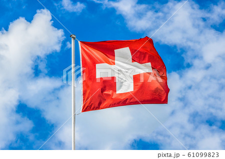 Swiss flag waving in the wind on a sunny day 61099823