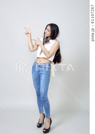 Asian woman wearing headphones dancing active Asian woman wearing headphones dancing active 61107267