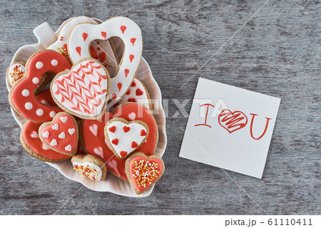 Decorated heart shape cookies and paper sheet with inscription i love you 61110411