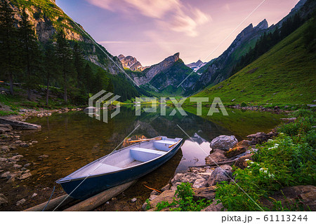 Sunset over the Seealpsee lake with a boat in the Swiss Alps, Switzerland 61113244