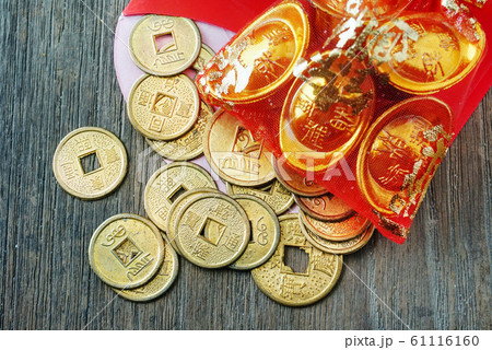 Close up topview coins spread out from red envelope , chinese new year decotation concept. 61116160