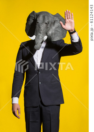 man with an elephant mask on a yellow background 61124143