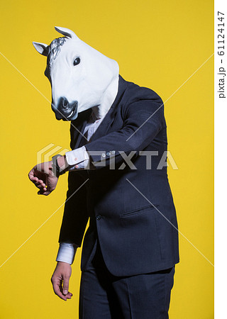 man with horse mask on yellow background man with horse mask on yellow background 61124147