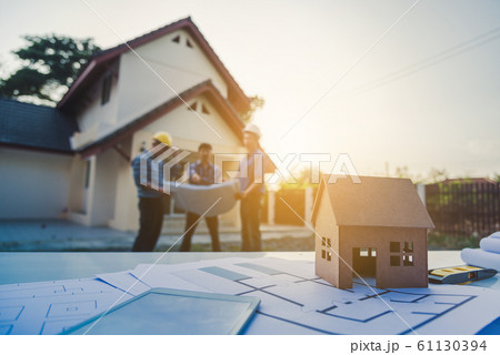 Engineer housing plan working together focus at 61130394