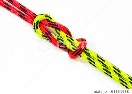 Reef, Hercules, square, double or brother hood Binding knot binding two colored (red and green) ropes. nautical loop used to secure rope or fishing line around an object. Isolated on white background Reef, Hercules, square, double or brother hood Binding knot binding two colored (red and green) ropes. nautical loop used to secure rope or fishing line around an object. Isolated on white background 61131988