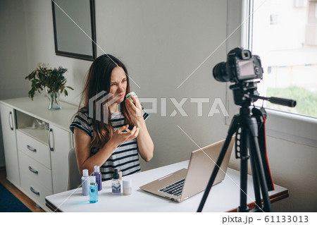 Girl videoblogger records video. Girl videoblogger records video. 61133013