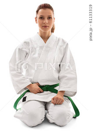 Calm young girl in a kimono kneeling down Calm young girl in a kimono kneeling down 61133319