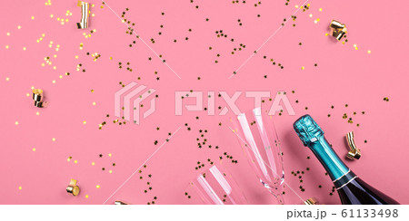 Champagne bottle and flutes on pink. Confetti Champagne bottle and flutes on pink. Confetti 61133498