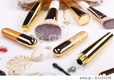 Set of brushes and cosmetic products in a cosmetic bag on a white background. Set of brushes and cosmetic products in a cosmetic bag on a white background. 61134159