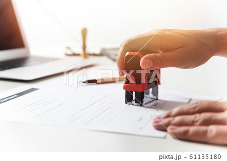 Lawyer working in office. Notary signs document Lawyer working in office. Notary signs document 61135180
