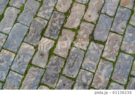 Background of stone pavement on the road in the Portuguese city of Albufeira. Background of stone pavement on the road in the Portuguese city of Albufeira. 61136238