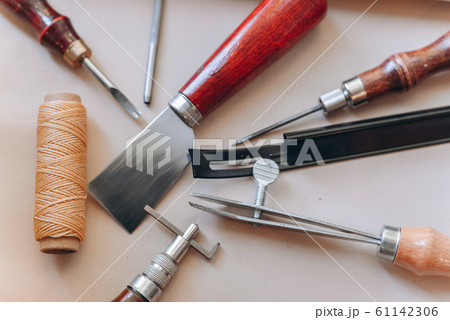 set of leathercraft tools - Slickers, Nylon hammers, Edge Creaser, Burnishers, Swivel knifes, Edge Beveler Skiving, Prongs Lacing Stitching Chisels isolated on white background 61142306