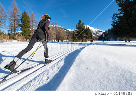 Girl practices Nordic skiing with alternating step Girl practices Nordic skiing with alternating step 61149285