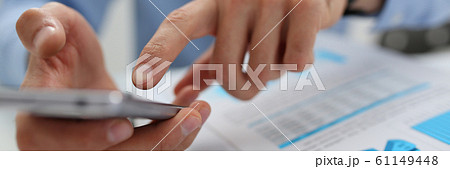 A businessman holds a new smartphone in his hand A businessman holds a new smartphone in his hand 61149448
