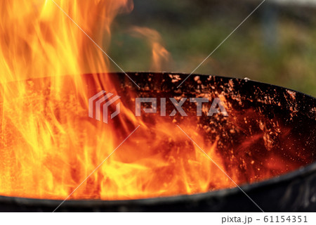 Close-up of flames in an old blackened metal bin 61154351