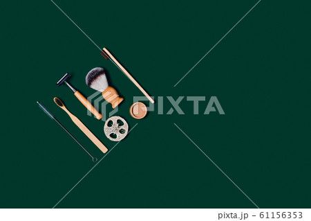 Zero waste accessories on green background. 61156353