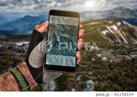 Smartphone GPS navigator in man's hand. Smartphone GPS navigator in man's hand. 61156354