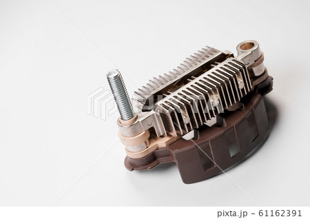 Close-up of a new relay regulator equalizing the voltage in the generator. New auto parts Close-up of a new relay regulator equalizing the voltage in the generator. New auto parts 61162391