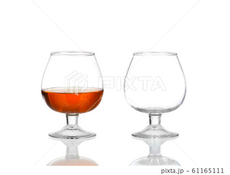 Two brandy glasses (empty and with alcohol) Two brandy glasses (empty and with alcohol) 61165111