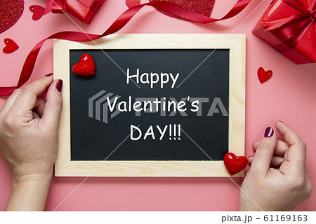 Valentine's day background. Female hands holding Valentine's day background. Female hands holding 61169163