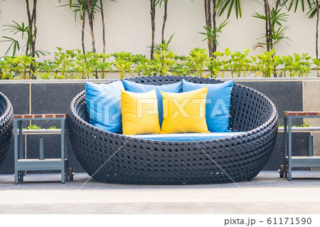 Outdoor patio in the garden with sofa chair and pillow decoration Outdoor patio in the garden with sofa chair and pillow decoration 61171590
