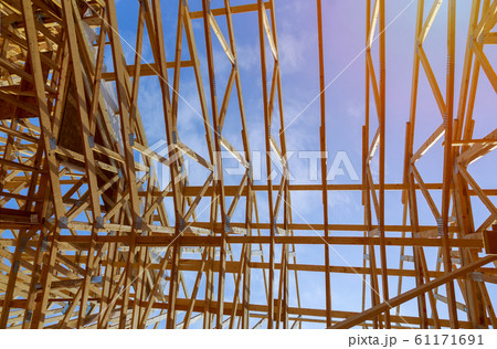 New construction home framing against a blue sky 61171691
