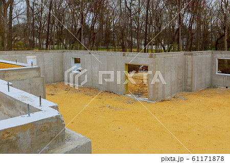 House in the foundation for a new building with 61171878