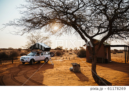 4x4 vehicle with roof top tent camping in Namibia desert during sunset, Africa 4x4 vehicle with roof top tent camping in Namibia desert during sunset, Africa 61178269