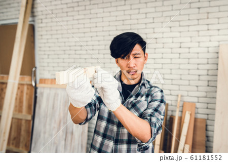 Carpenter Man is Working Timber Woodworking in Carpentry Shop 61181552