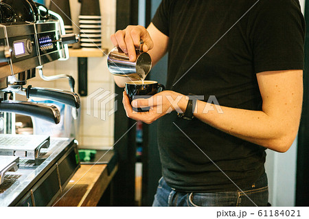 Barista pours coffee 61184021