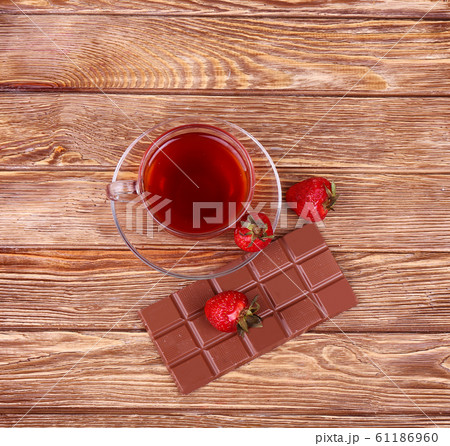 A cup of tea or coffee. Dark Chocolate. Wooden A cup of tea or coffee. Dark Chocolate. Wooden 61186960
